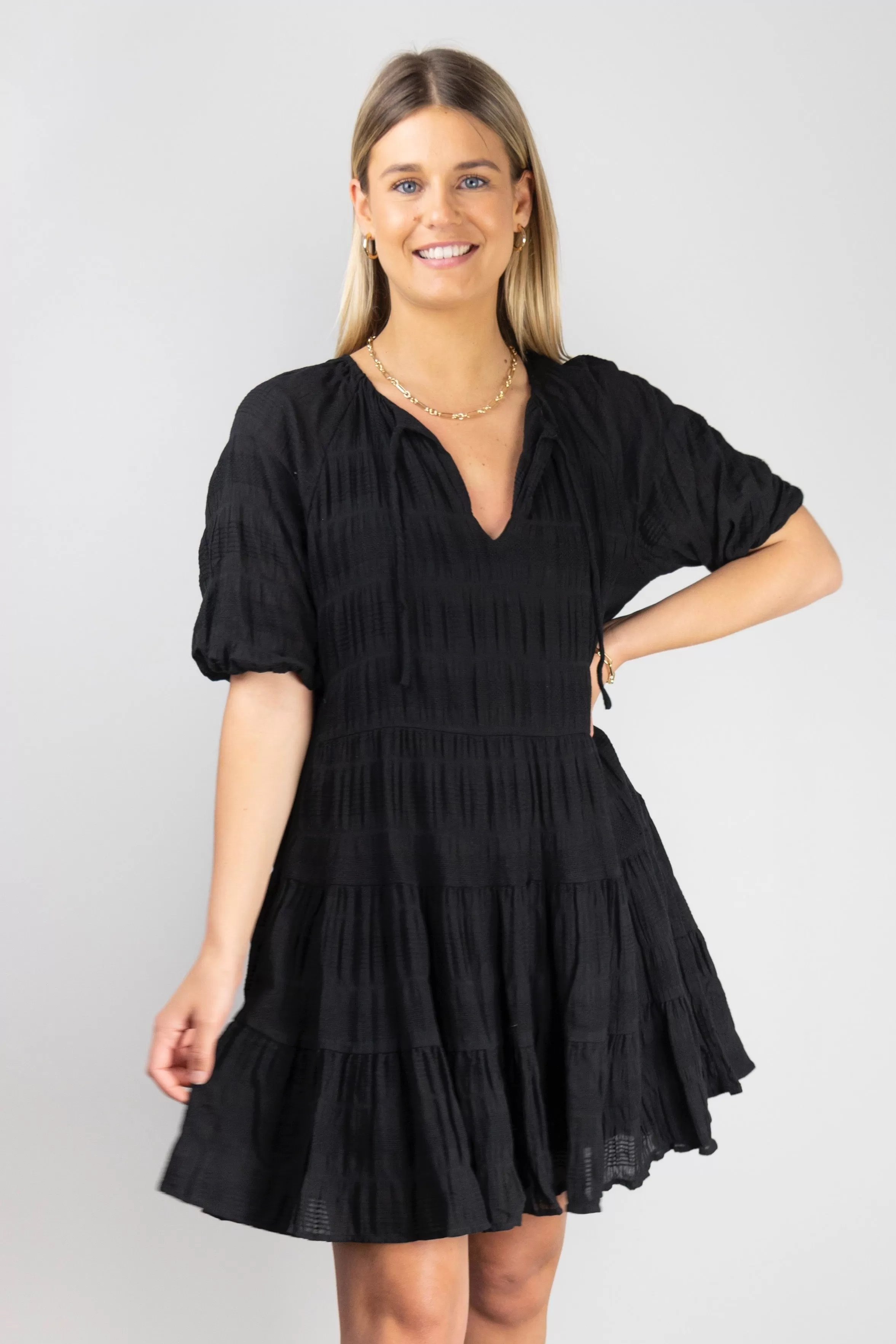 Playful Black Shirred Cotton SS V Neck Tiered Mini Dress